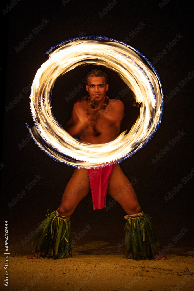 Male Fire dancer with illuminated spinning flaming torch - obrazy, fototapety, plakaty 