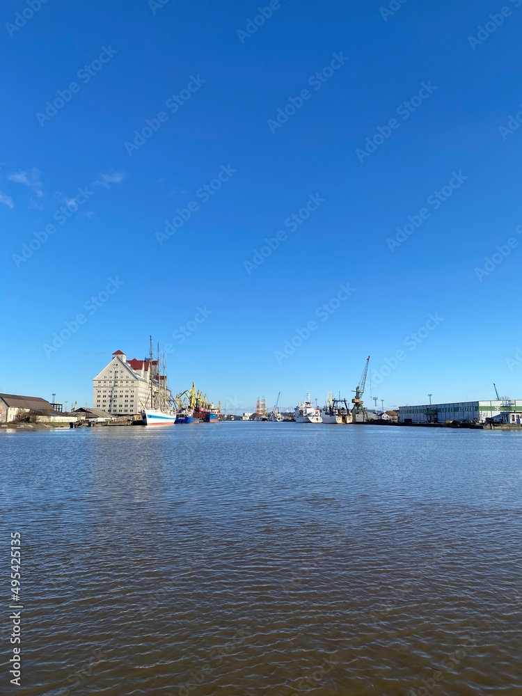 Russia, Kaliningrad, hoisting cranes in the commercial port. Ship at the pier.
