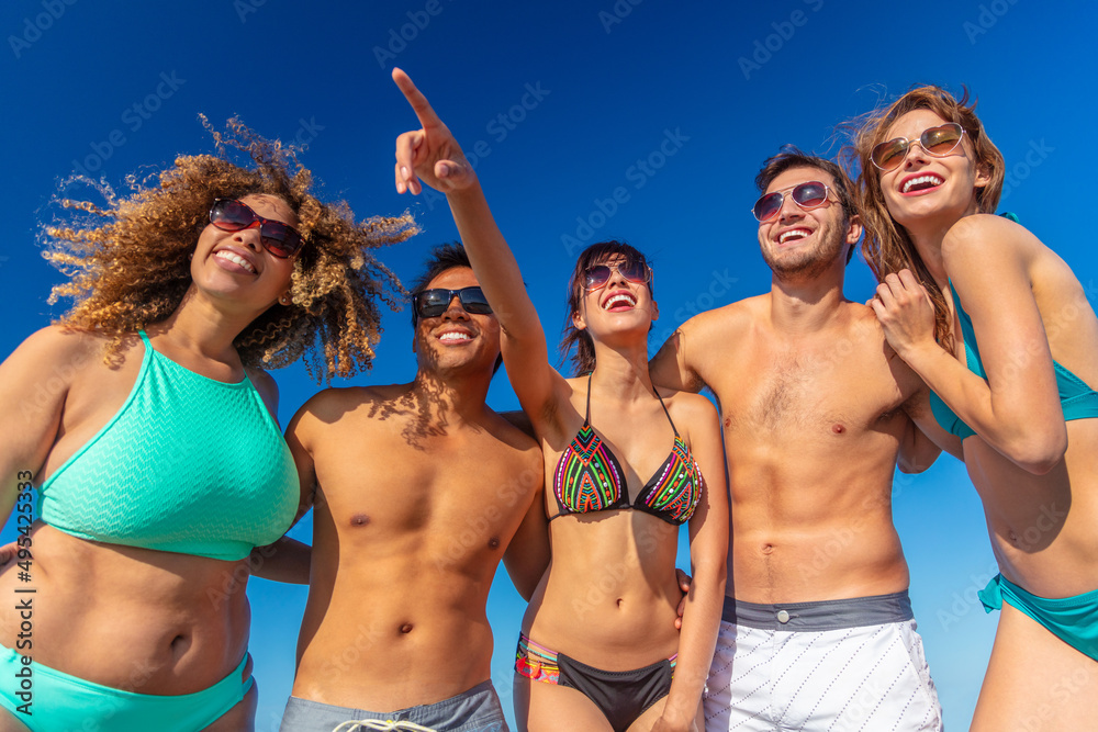 Multi ethnic friends in swimwear on Summer vacation