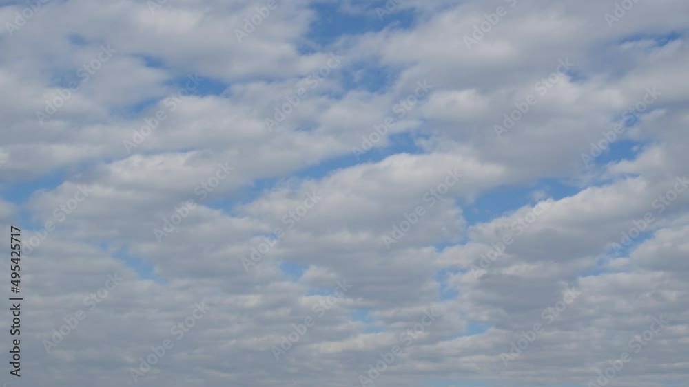 Layer of altocumulus stratiformis clouds moving across sky in fast forward, time lapse of clouds in atmosphere Layer of altocumulus stratiformis clouds moving across sky in fast forward, time lapse of clouds in atmosphere