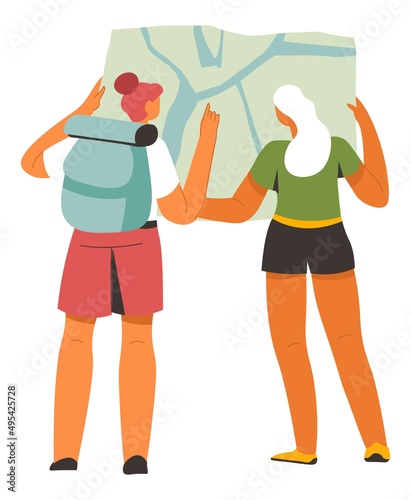 Backpackers reading map for trekking in mountains
