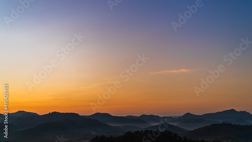 sunset over the mountains in the morning with colorful orange sunrise © Nature Peaceful 