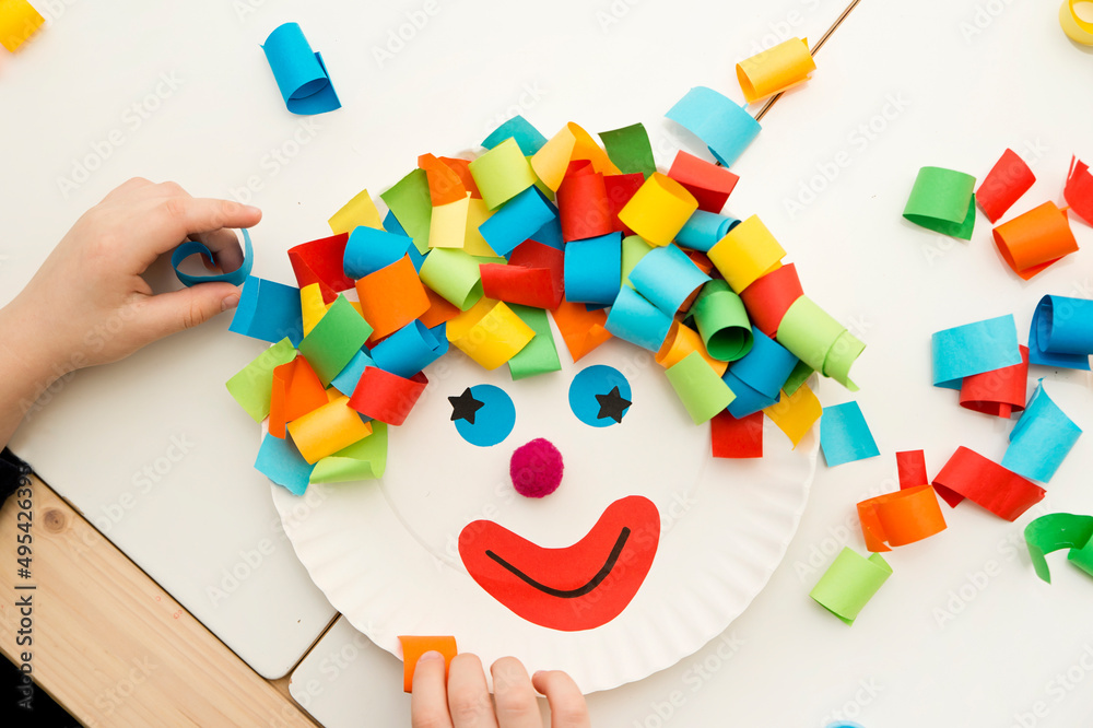 Paper plate clown. DIY games at home, activities for pre-school Kids. 5  minute crafts. Children joy and funny to cut a hair for clown. Red Nose Day  theme. Stock Photo | Adobe