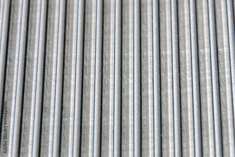 Obraz premium shiny waves of metal. bent aluminum foil. macro photo of corrugation