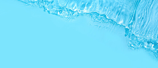 Transparent blue clear water wave surface texture with splashes and bubbles. Abstract summer banner background Water waves in sunlight with copy space Cosmetic moisturizer micellar toner emulsion