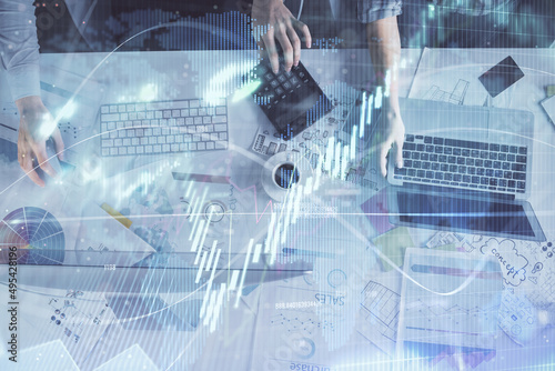 Multi exposure of man and woman working together and financial chart hologram. Business concept. Computer background.