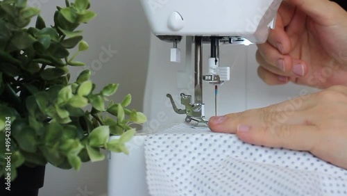 woman is using sewing machine. sewing process close up . High quality