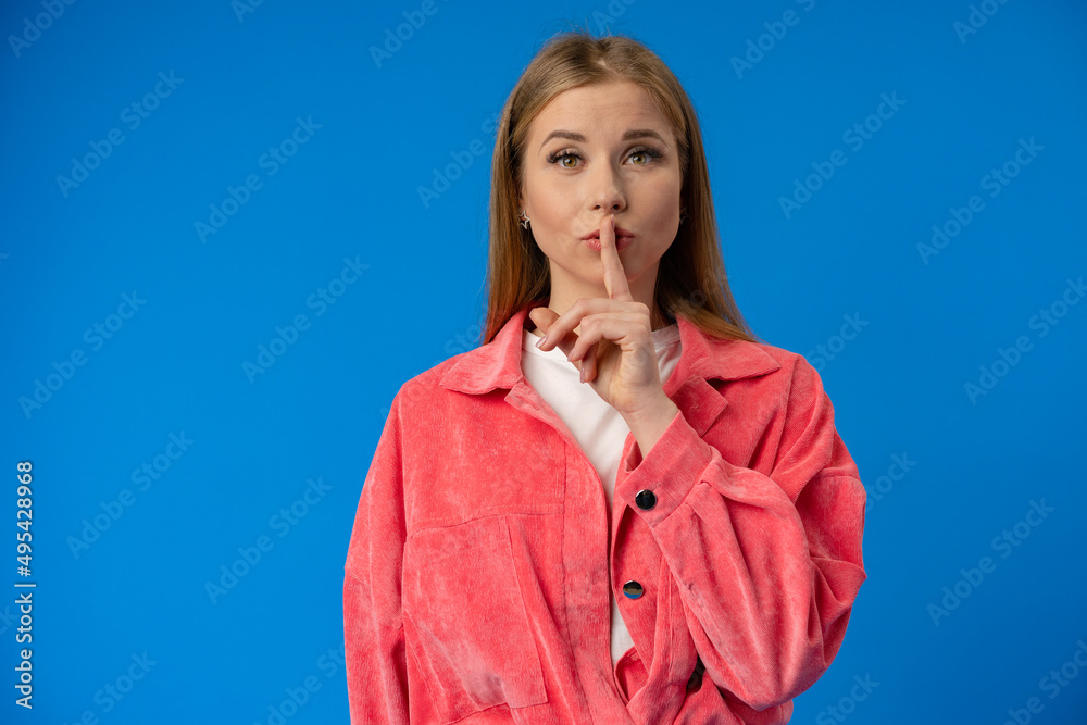 Young pretty woman showing silence gesture over blue background Young pretty woman showing silence gesture over blue background