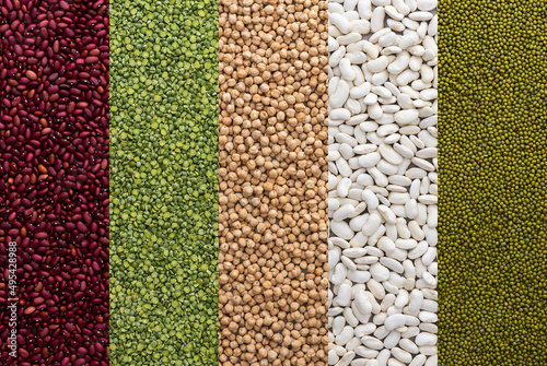 Different types of legumes, chickpeas and mung beans, white and red beans and green peas , top view