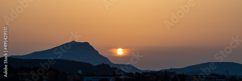 the Sainte Victoire mountain in the light of a hazy spring sunrise