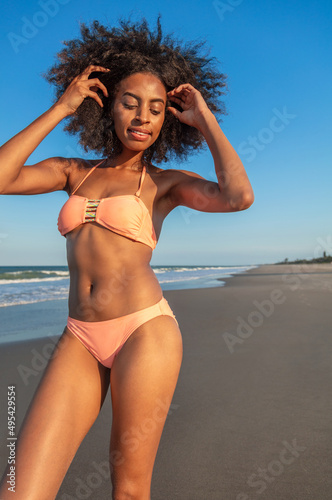 Smiling Afro American woman in swimwear on beach