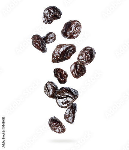 Delicious prunes in the air, isolated on a white background
