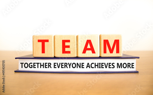 TEAM together everyone achieves more symbol. Concept words TEAM together everyone achieves more on cubes. White background. Business, motivational TEAM together everyone achieves more concept.