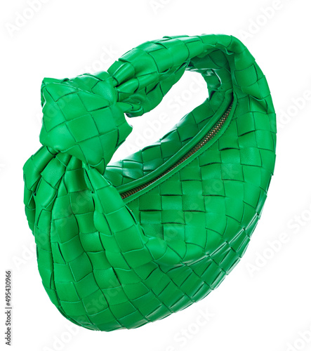 Gorgeous little handbag made of woven bright green leather, isolated on a white background. Expensive women's accessories.