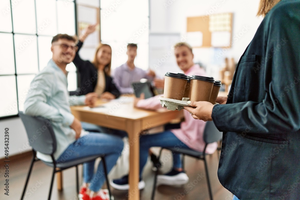 Group of business workers smiling happy working at the office. Partner man holding tray with take away coffee. Group of business workers smiling happy working at the office. Partner man holding tray with take away coffee.