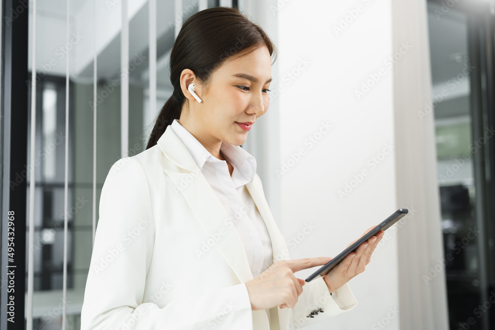 Confidence woman concept, Businesswoman using tablet to checking business plan and financial report Confidence woman concept, Businesswoman using tablet to checking business plan and financial report