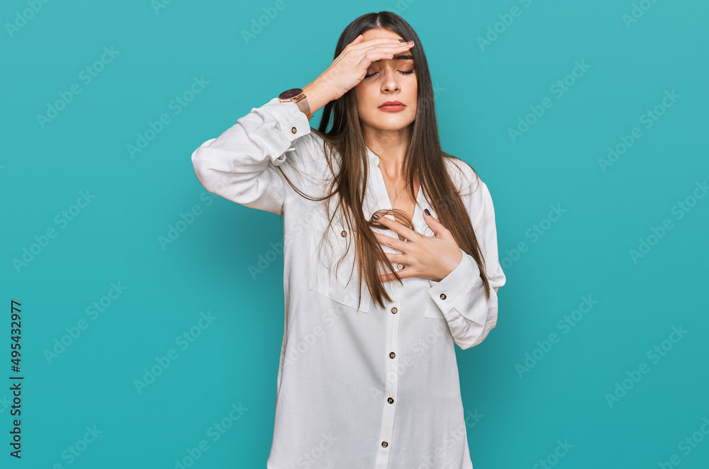 Young beautiful woman wearing casual white shirt touching forehead for illness and fever, flu and cold, virus sick Young beautiful woman wearing casual white shirt touching forehead for illness and fever, flu and cold, virus sick