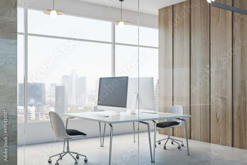 Contemporary concrete office interior with empty mock up place on computer monitor  furniture  equipment  window with city view and daylight. 3D Rendering.