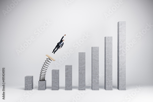 Concept of business boost and growth. Superhero businessman flying off of springboard to business chart top. photo
