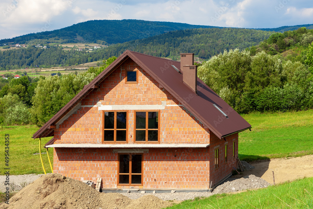 Building a house in a mountain landscape Building a house in a mountain landscape
