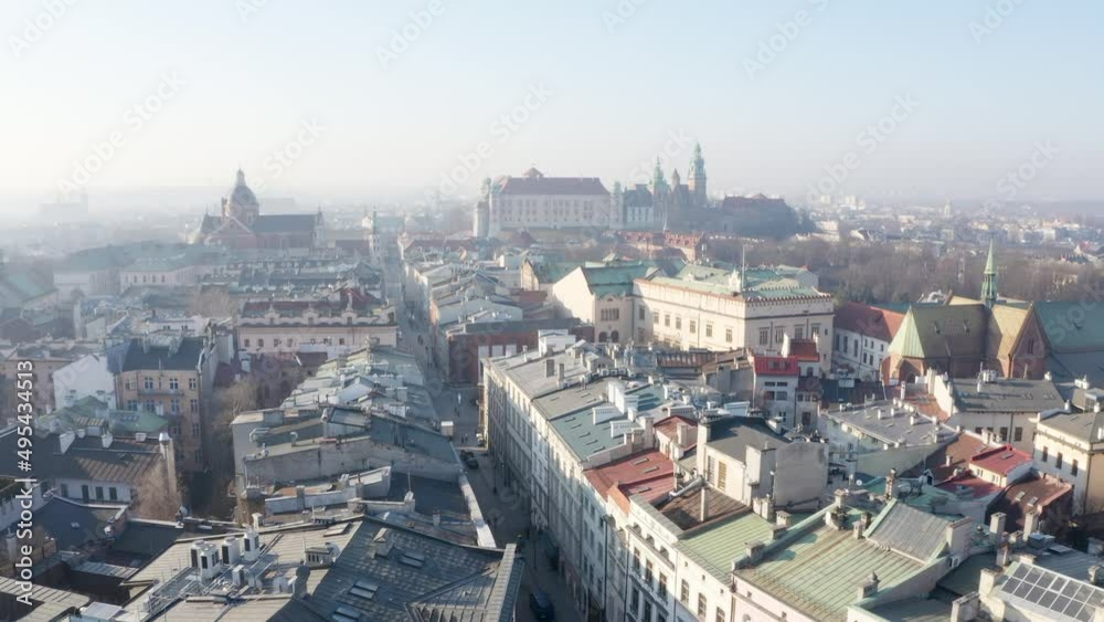 view to Wawel Royal Castle from above Krakow Poland city center panoramic. Aerial drone city photo. Early summy morning soft light and beautiful mist. Historical old town streets video footage view to Wawel Royal Castle from above Krakow Poland city center panoramic. Aerial drone city photo. Early summy morning soft light and beautiful mist. Historical old town streets video footage