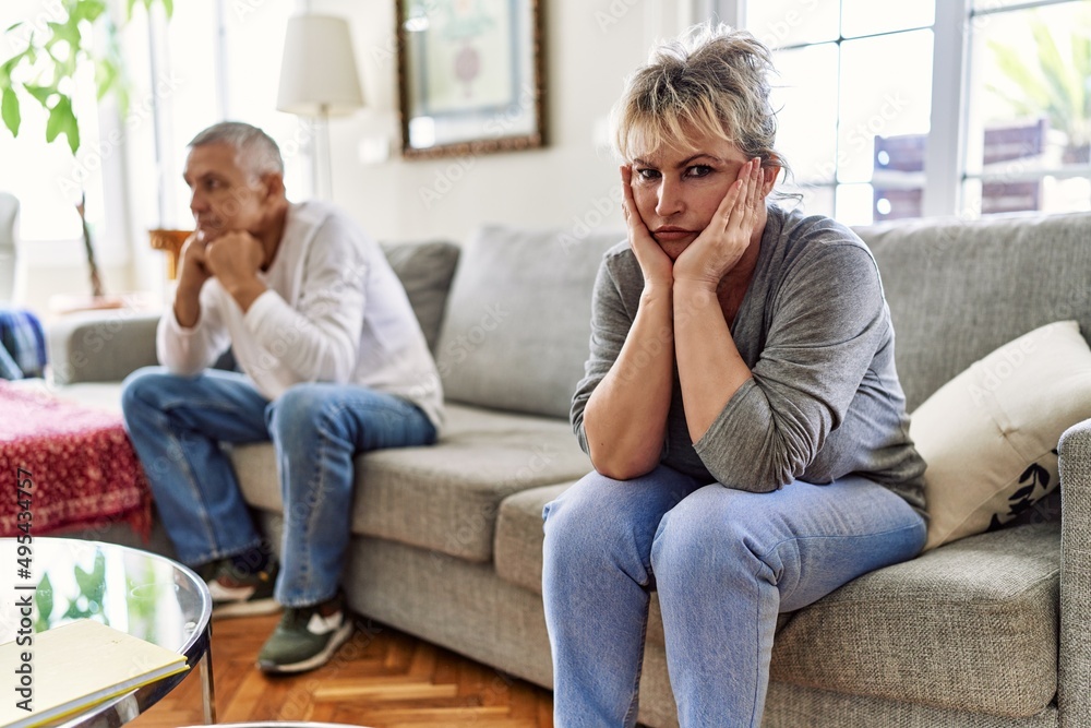 Fototapeta premium Senior caucasian couple in trouble sitting on the sofa at home.