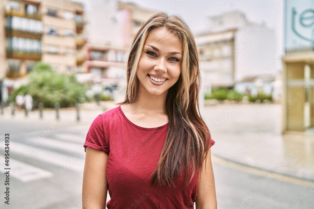 Young caucasian girl smiling happy standing at the city. Young caucasian girl smiling happy standing at the city.