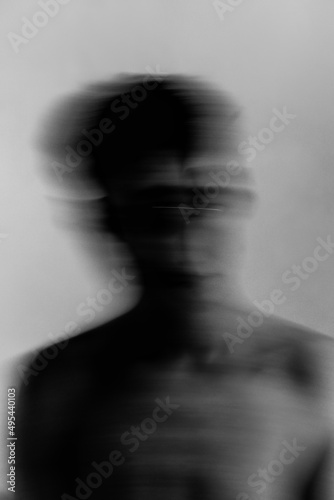 Grayscale blurry portrait of topless man against light background photo