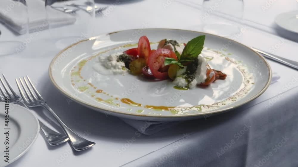 Bocconcini Cheese and Heirloom Tomatoes Salad approaching toward into focus stabilized bright beautiful fine dining happy fancy special occasion celebration wedding food Bocconcini Cheese and Heirloom Tomatoes Salad approaching toward into focus stabilized bright beautiful fine dining happy fancy special occasion celebration wedding food