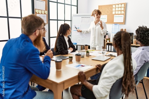 Group of business workers listening caucasian boss woman conference at the office.