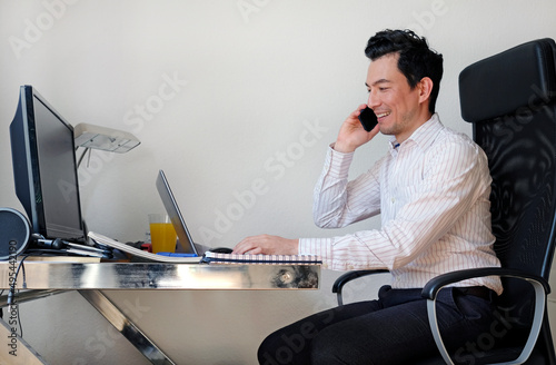 Man in light dress shirt sitting working from home