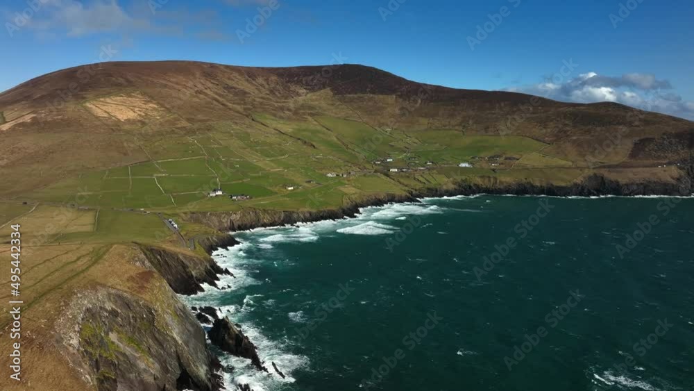 Coumeenoole Bay, Kerry, Ireland, March 2022. Drone orbits the cliffs at Dunmore head on the Dingle Peninsula while facing east towards Glanfahan and Ventry. Coumeenoole Bay, Kerry, Ireland, March 2022. Drone orbits the cliffs at Dunmore head on the Dingle Peninsula while facing east towards Glanfahan and Ventry.