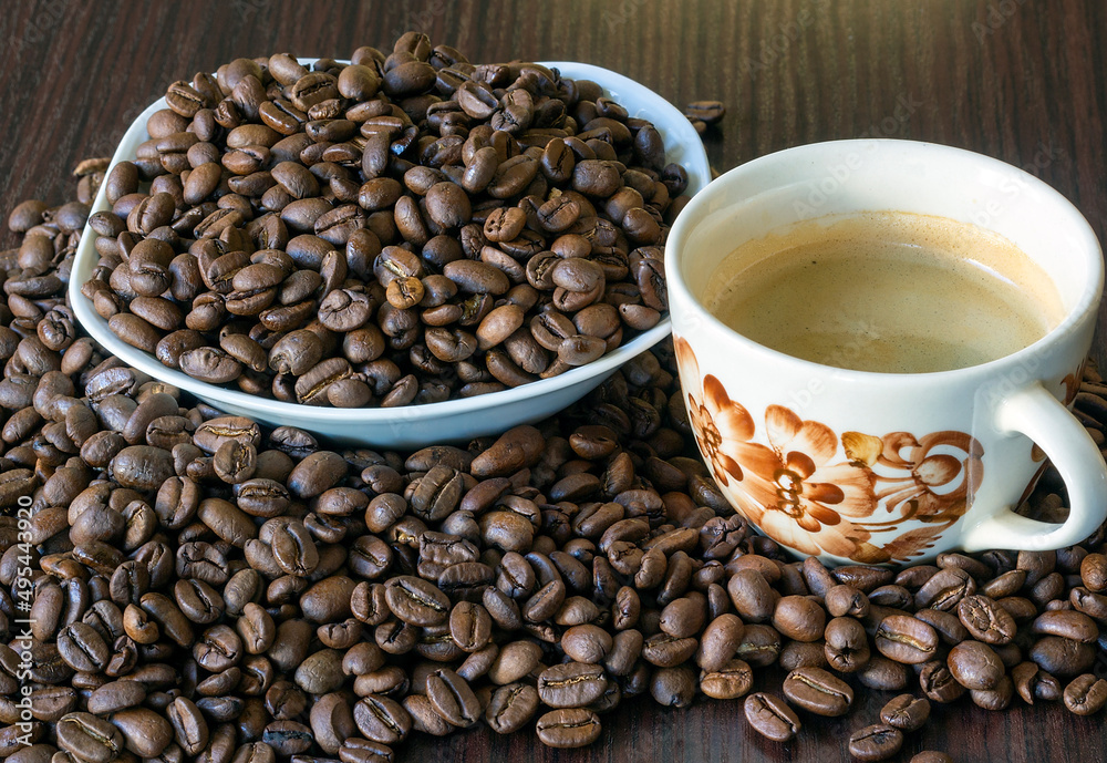 Fototapeta premium A cup of coffee and a bowl with coffee beans