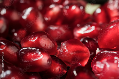 Juicy and ripe pomegranate seeds. Macrophotography. Red pomegranate seeds close-up.