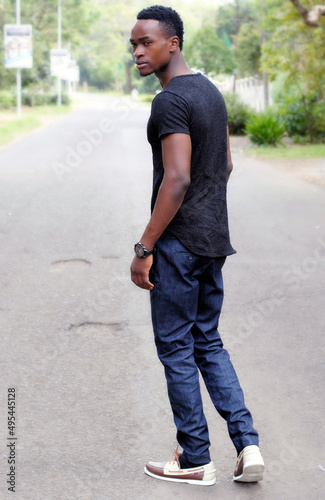 Portrait of young man standing on street photo