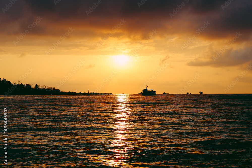 Sunset at sea. Orange sun, summer. Ships. High quality photo