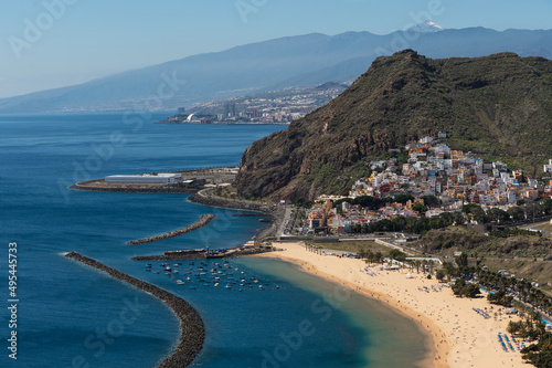Aerial view of Santa Cruz, Canary Islands. Urban settlements along the coast with beautiful large beach during a sunny day. © Pintau Studio