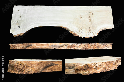 Pieces of wood isolated on black background. Texture of a polished cut of a tree close-up. Side view. Woodworking, carpentry production.