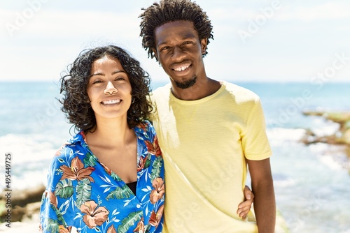 Young beautiful couple smiling happy and hugging standing at the beach. © Krakenimages.com