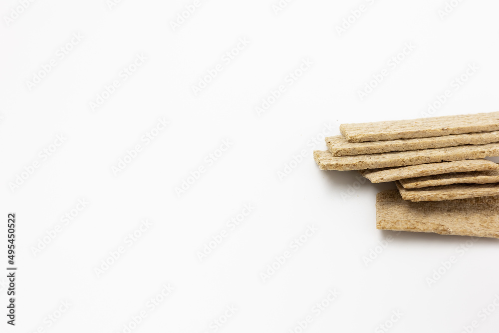 Obraz premium A few dry wheat diet light thin small loaves of bread on a white background isolated