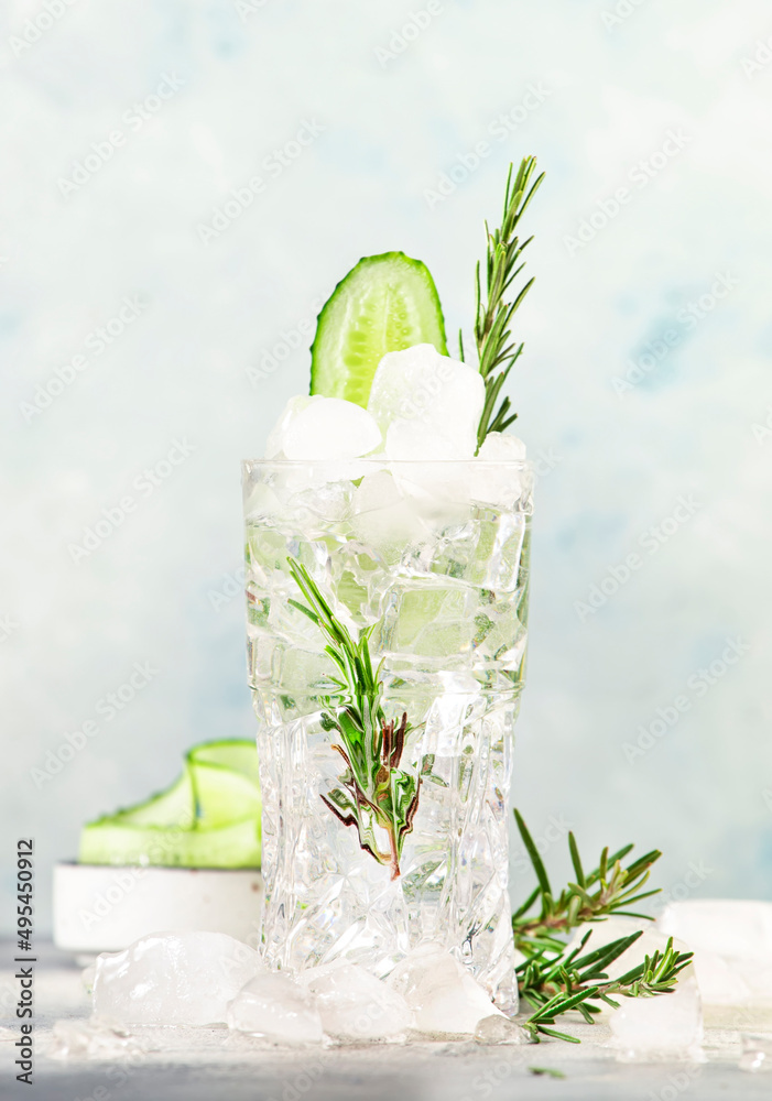 Gin tonic with cucumber, alcoholic cocktail drink with dry gin, rosemary,  tonic, fresh cucumber and ice cubes. Gray background, bar tools, copy space  Photos | Adobe Stock