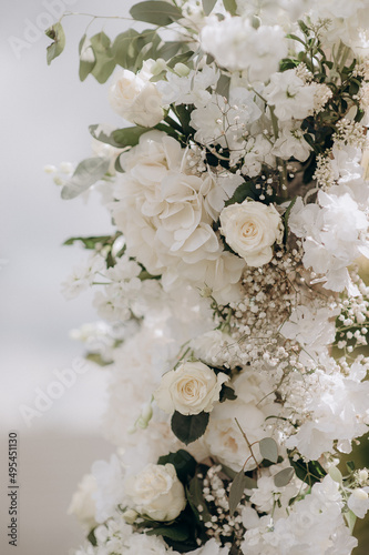white flower arrangements in the decor of the wedding ceremony