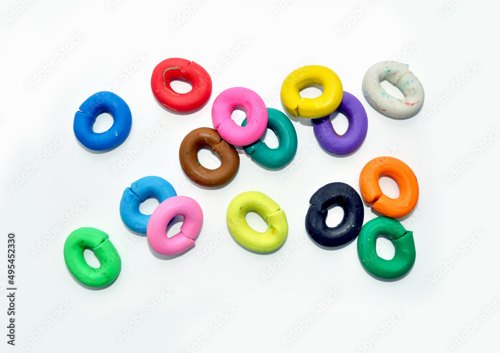 Naklejka premium multicolored plasticine circles on a white background