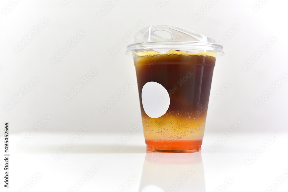 Iced Espresso Tonic. Close up of espresso shot serve with tonic water or Richie Soda on a white table and copy space. Iced Espresso Tonic. Close up of espresso shot serve with tonic water or Richie Soda on a white table and copy space.