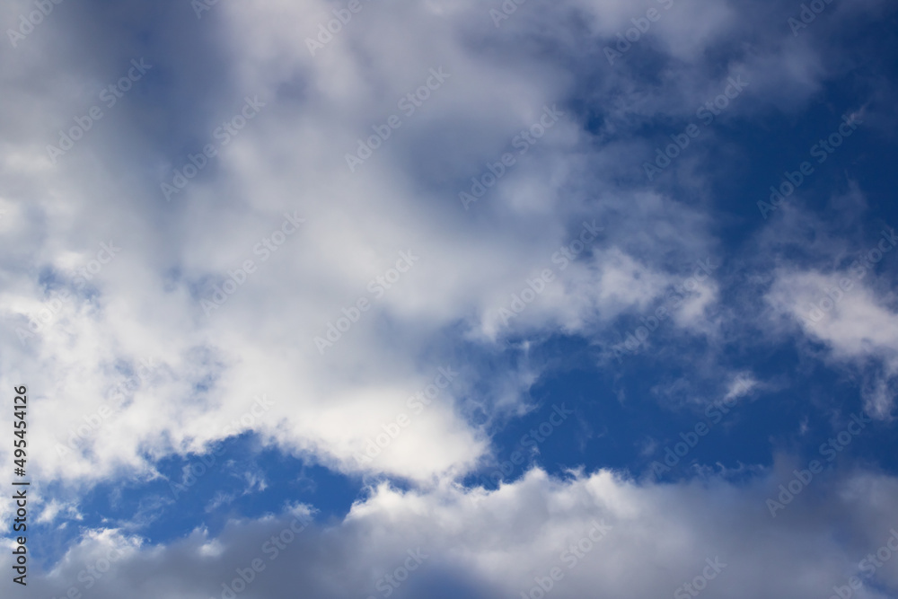 Fluffy clouds in the bright blue sky