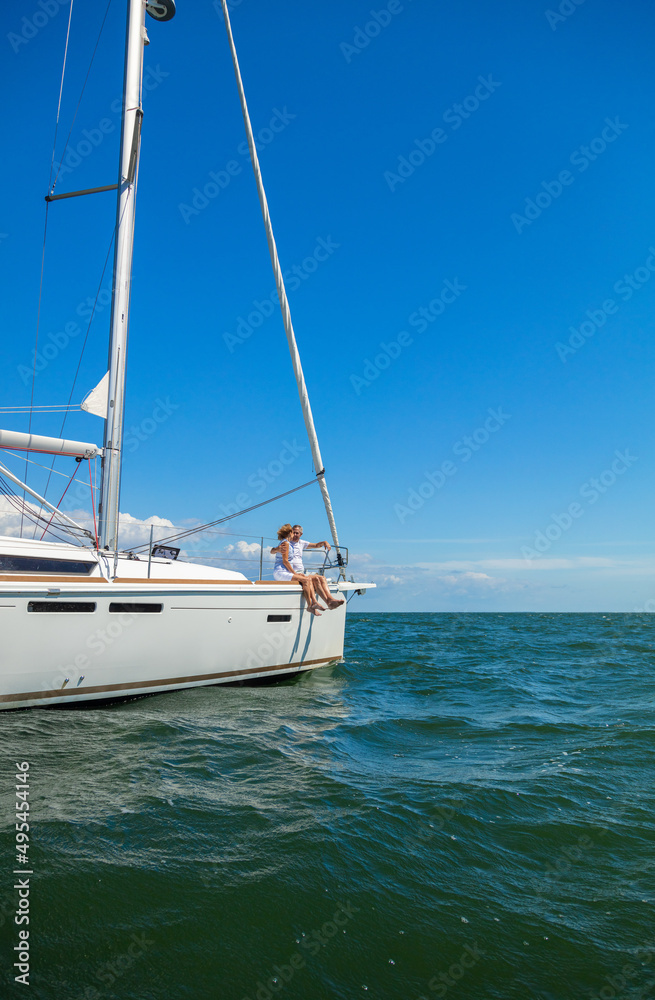 Fototapeta premium Luxury yacht sailing ocean with senior couple relaxing