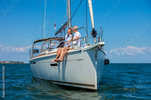 Adventurous senior American couple sailing on luxury yacht