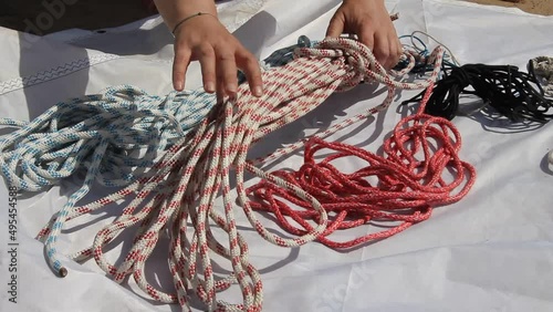 Man pulling a rope on a sailing boat, Sailor pulling rope on sailboat 