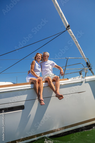 Loving senior couple enjoying retirement on luxury yacht