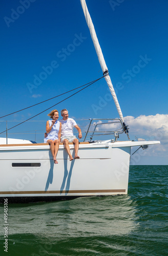 Relaxed senior American couple sailing on luxury yacht